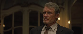 Movie still from “Creed II” (2018), directed by Steven Caple Jr. – An older man in a suit and tie looking to his left; Close Up shot, Low angle