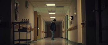 Movie still from “Creed II” (2018), directed by Steven Caple Jr. – A man standing in the hallway of a hospital; Wide shot, Low angle