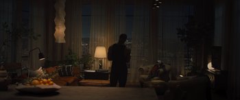 Movie still from “Creed II” (2018), directed by Steven Caple Jr. – A man standing in front of a window at night; Wide shot, High angle