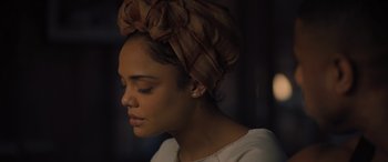 Movie still from “Creed II” (2018), directed by Steven Caple Jr. – A woman with a head wrap on her head; Close Up shot, Over the shoulder angle