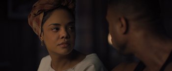 Movie still from “Creed II” (2018), directed by Steven Caple Jr. – A woman is looking at a man in the dark; Close Up shot, Over the shoulder angle