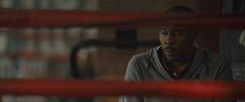 Movie still from “Creed II” (2018), directed by Steven Caple Jr. – A man in a boxing ring looking down at the ground; Close Up shot, Over the shoulder angle
