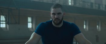 Movie still from “Creed II” (2018), directed by Steven Caple Jr. – A person wearing a blue shirt; Close Up shot, Low angle