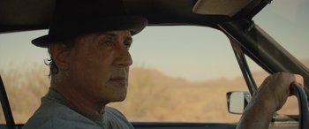 Movie still from “Creed II” (2018), directed by Steven Caple Jr. – A person in a car looking out the window; Close Up shot, Over the shoulder angle