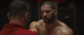 Movie still from “Creed II” (2018), directed by Steven Caple Jr. – A man that is looking into the mirror; Close Up shot, Over the shoulder angle