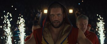 Movie still from “Creed II” (2018), directed by Steven Caple Jr. – A person wearing a robe; Close Up shot, Low angle