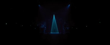 Movie still from “Creed II” (2018), directed by Steven Caple Jr. – A stage lit up with a blue triangle light; Extreme Wide shot, High angle