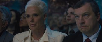 Movie still from “Creed II” (2018), directed by Steven Caple Jr. – A man and a woman are standing in front of a group of people; Close Up shot, Low angle