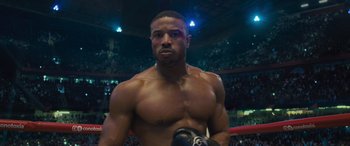 Movie still from “Creed II” (2018), directed by Steven Caple Jr. – A man that is in a boxing ring; Close Up shot, Low angle