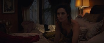 Movie still from “Cry Macho” (2021), directed by Clint Eastwood – A woman sitting on a bed looking at the camera; Medium shot, High angle
