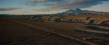 Movie still from “Cry Macho” (2021), directed by Clint Eastwood – An empty road in the middle of the desert; Extreme Wide shot, High angle