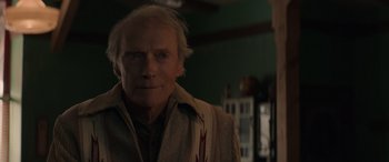 Movie still from “Cry Macho” (2021), directed by Clint Eastwood – An older man with a scar on his face; Close Up shot, Over the shoulder angle