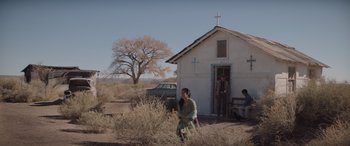 Movie still from “Cry Macho” (2021), directed by Clint Eastwood – A woman standing in front of an old church; Extreme Wide shot, Low angle