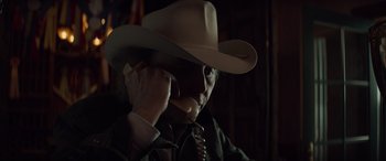 Movie still from “Cry Macho” (2021), directed by Clint Eastwood – A man wearing a cowboy hat talking on a phone; Close Up shot, Low angle