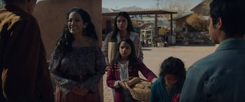 Movie still from “Cry Macho” (2021), directed by Clint Eastwood – A group of people standing next to each other on a street; Medium shot, Over the shoulder angle