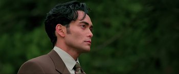 Movie still from “Crying Freeman” (1995), directed by Christophe Gans – A person wearing a suit and tie; Close Up shot, Low angle