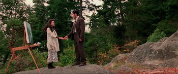 Movie still from “Crying Freeman” (1995), directed by Christophe Gans – A man and a woman standing next to each other on top of a hill; Wide shot, High angle