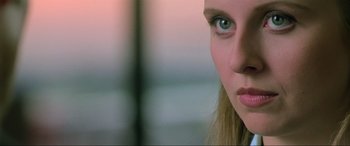 Movie still from “Crying Freeman” (1995), directed by Christophe Gans – A woman's face with a blurry background; Close Up shot, Over the shoulder angle
