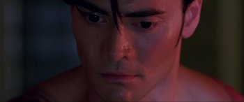 Movie still from “Crying Freeman” (1995), directed by Christophe Gans – A man's face in the dark; Close Up shot, High angle