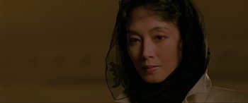 Movie still from “Crying Freeman” (1995), directed by Christophe Gans – A person wearing a veil; Close Up shot, Over the shoulder angle