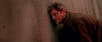 Movie still from “Crying Freeman” (1995), directed by Christophe Gans – A man with blood all over his face; Close Up shot, Low angle
