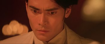 Movie still from “Crying Freeman” (1995), directed by Christophe Gans – A person with a crying face; Close Up shot, Low angle