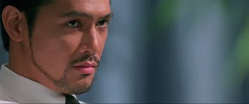 Movie still from “Crying Freeman” (1995), directed by Christophe Gans – A man's face with a mustache; Close Up shot, Low angle