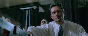 Movie still from “Crying Freeman” (1995), directed by Christophe Gans – A person wearing a suit and a tie; Close Up shot, Low angle