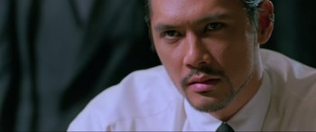 Movie still from “Crying Freeman” (1995), directed by Christophe Gans – A person wearing a shirt and tie; Close Up shot, Low angle