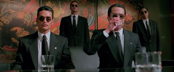 Movie still from “Crying Freeman” (1995), directed by Christophe Gans – A group of men wearing suits and ties; Medium shot, Low angle