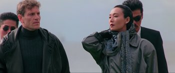 Movie still from “Crying Freeman” (1995), directed by Christophe Gans – A woman standing next to another woman wearing a black jacket; Close Up shot, Over the shoulder angle