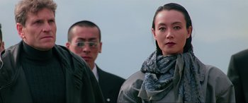 Movie still from “Crying Freeman” (1995), directed by Christophe Gans – A man and a woman standing next to each other; Close Up shot, Low angle