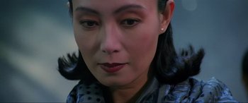Movie still from “Crying Freeman” (1995), directed by Christophe Gans – A woman's face with dark eyes; Close Up shot, High angle