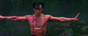 Movie still from “Crying Freeman” (1995), directed by Christophe Gans – A shirtless man with blood all over his chest and torso; Medium shot, Low angle