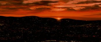 Movie still from “The Wrestler” (2008), directed by Darren Aronofsky – The sun is setting over a large city; Extreme Wide shot, High angle