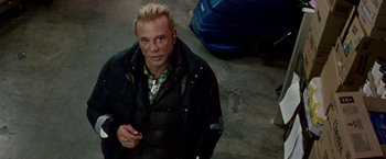 Movie still from “The Wrestler” (2008), directed by Darren Aronofsky – A man with blonde hair and a black jacket; Close Up shot, High angle