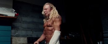 Movie still from “The Wrestler” (2008), directed by Darren Aronofsky – A man with long blond hair is holding a white towel; Medium shot, Low angle