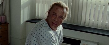 Movie still from “The Wrestler” (2008), directed by Darren Aronofsky – A man in a hospital bed with a scar on his face; Close Up shot, Over the shoulder angle