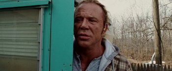 Movie still from “The Wrestler” (2008), directed by Darren Aronofsky – A person wearing headphones near a wall; Close Up shot, Low angle