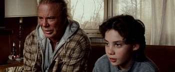 Movie still from “The Wrestler” (2008), directed by Darren Aronofsky – A man and a girl sitting next to each other; Close Up shot, Over the shoulder angle