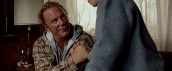 Movie still from “The Wrestler” (2008), directed by Darren Aronofsky – A man in a plaid jacket talking to another man in a plaid jacket; Close Up shot, Over the shoulder angle