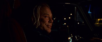 Movie still from “The Wrestler” (2008), directed by Darren Aronofsky – A man sitting in the back seat of a car at night; Close Up shot, Over the shoulder angle