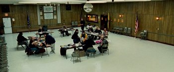 Movie still from “The Wrestler” (2008), directed by Darren Aronofsky – A group of people sitting at a table in a room; Extreme Wide shot, High angle