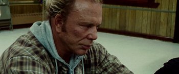 Movie still from “The Wrestler” (2008), directed by Darren Aronofsky – A person wearing a plaid shirt; Close Up shot, Over the shoulder angle