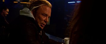 Movie still from “The Wrestler” (2008), directed by Darren Aronofsky – A man sitting at a table drinking a cup of coffee; Close Up shot, Over the shoulder angle