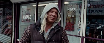 Movie still from “The Wrestler” (2008), directed by Darren Aronofsky – A man with long white blonde hair wearing a hooded jacket; Medium shot, Low angle