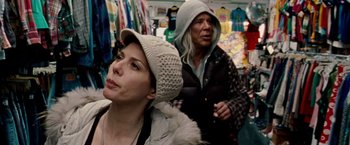 Movie still from “The Wrestler” (2008), directed by Darren Aronofsky – A woman wearing a white hat and a man wearing a black jacket; Medium shot, Over the shoulder angle