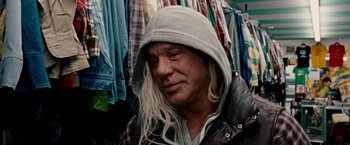 Movie still from “The Wrestler” (2008), directed by Darren Aronofsky – A man with long blonde hair wearing a hooded jacket; Close Up shot, Over the shoulder angle