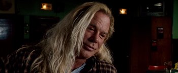 Movie still from “The Wrestler” (2008), directed by Darren Aronofsky – A person with long blonde hair; Close Up shot, Low angle