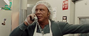 Movie still from “The Wrestler” (2008), directed by Darren Aronofsky – A man wearing a head covering talking on a phone; Close Up shot, Low angle